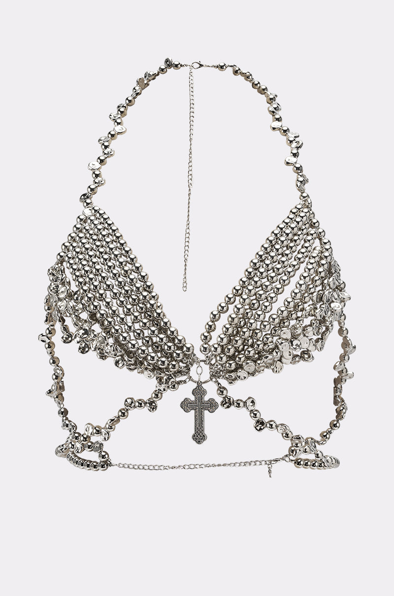 The KEKE BODY CHAIN is a halter-style silver body chain bralette with rows of small silver beads and coins, a large cross pendant at the center, and intricate chain details—ideal as bold festival jewelry. 2