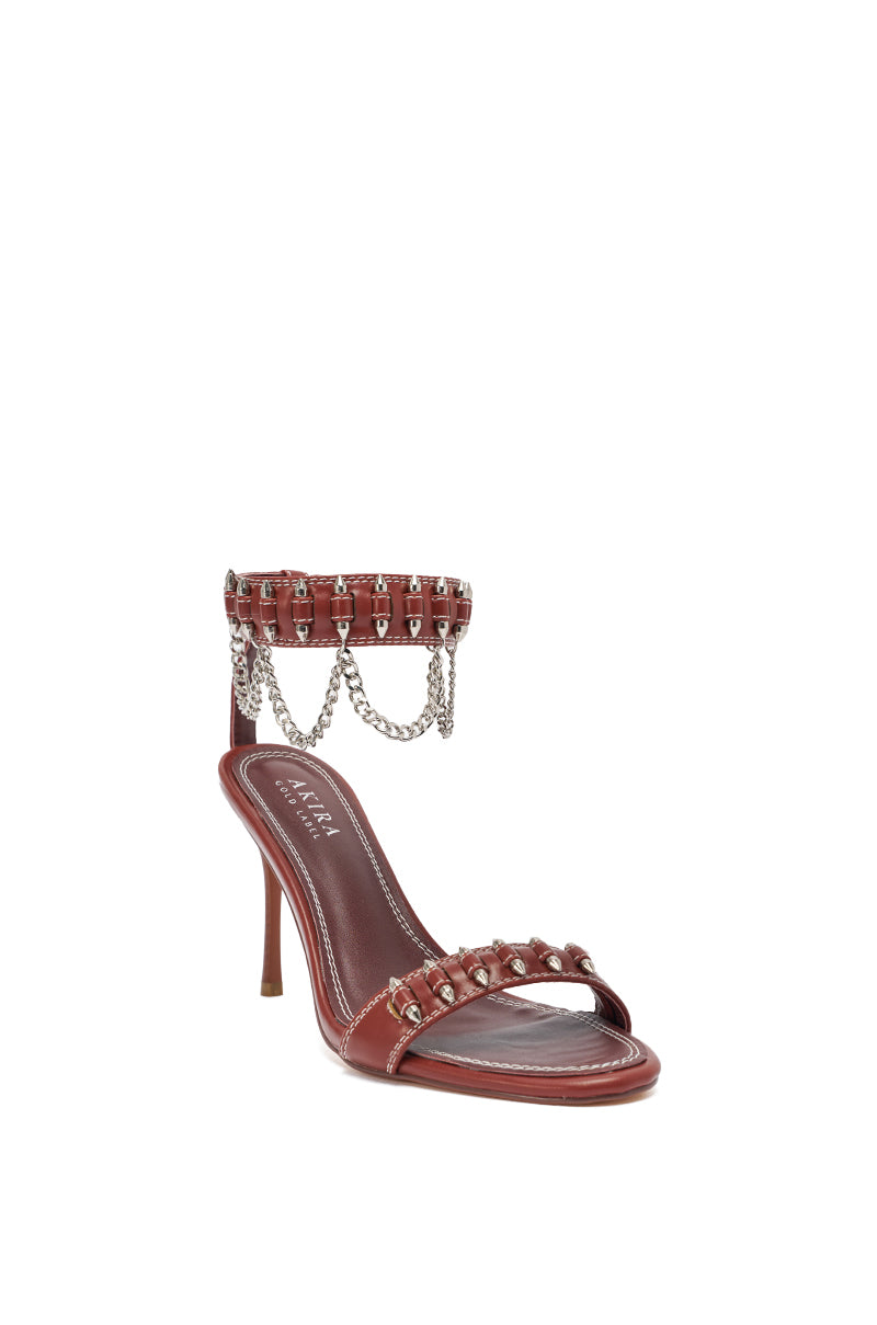 The AKIRA GOLD DELCROIX BROWN STILETTO SANDAL boasts a sleek faux leather stiletto style with silver chain and stud accents, an open toe, and an elegant ankle strap for a chic finish. 4
