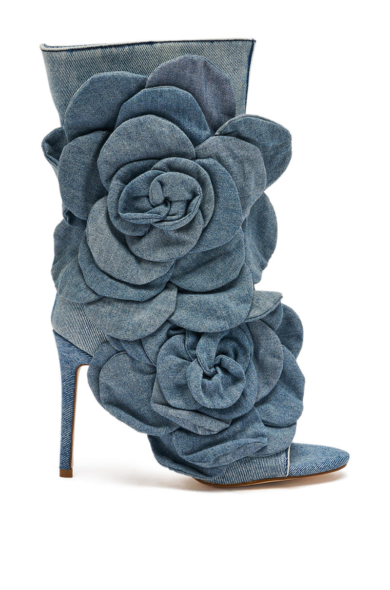 The AZALEA WANG DELMARE DENIM FLORAL OPEN TOE BOOTIE features denim fabric, floral appliqué accents, and a bold stiletto heel.