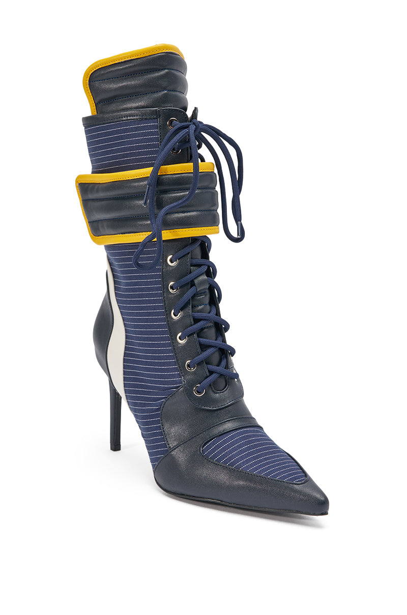 The AKIRA GOLD DEMAND NAVY STILETTO BOOTIE features blue pinstriped fabric, black faux leather accents, front laces, a padded collar, and yellow trim for a bold, futuristic look. 3
