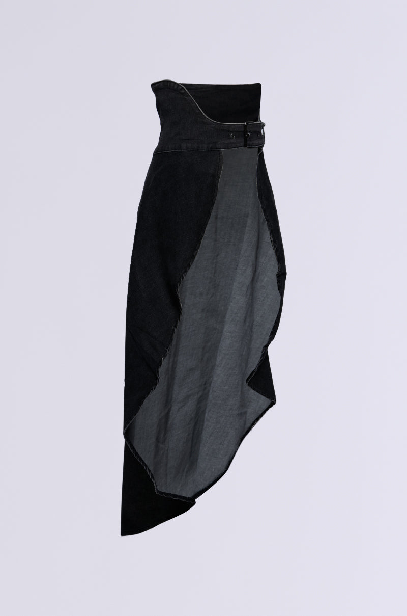 Introducing the TOO TUFF GREY DENIM BELT SKIRT: a high-rise fit with an asymmetrical black design featuring a stylish denim belt at the waist. This skirt highlights various textures and panels, creating a distinctive silhouette that tapers towards the bottom. Set against a plain, light-colored background, it stands out effortlessly.