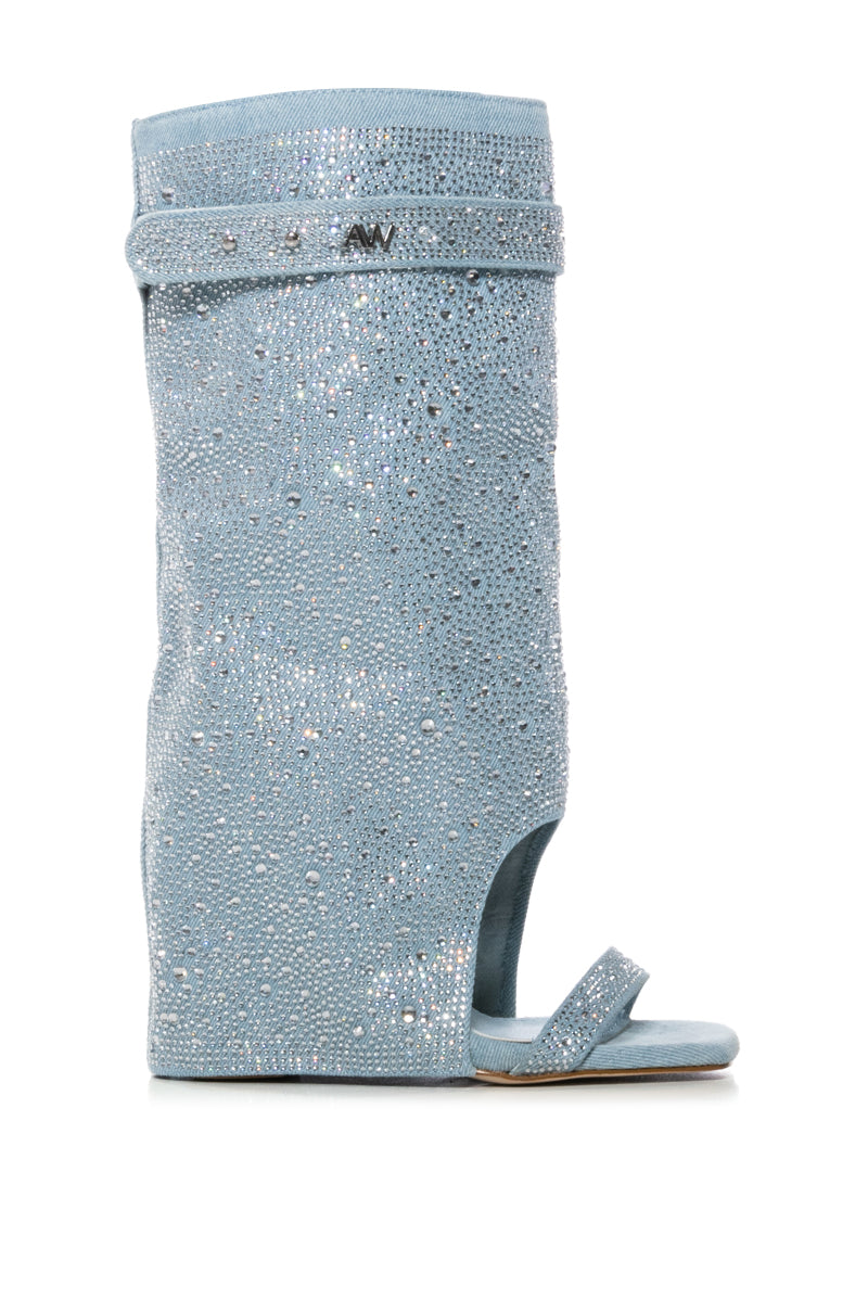 The AZALEA WANG DESARAY RHINESTONE OPEN TOE WEDGE BOOTIE is a shimmering blue rhinestone-embellished boot featuring an open toe, metallic knee strap details, and sparkling gem accents, offering a glamorous denim sandal bootie look.