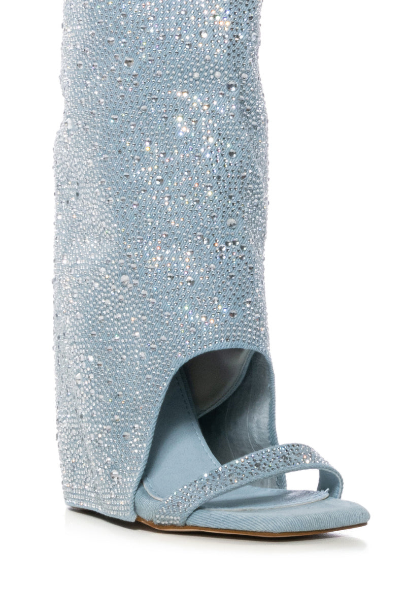 Close-up of the AZALEA WANG DESARAY RHINESTONE OPEN TOE WEDGE BOOTIE, a stylish and elegant sandal with a sparkling light blue design, open toe, and rhinestone embellishments.