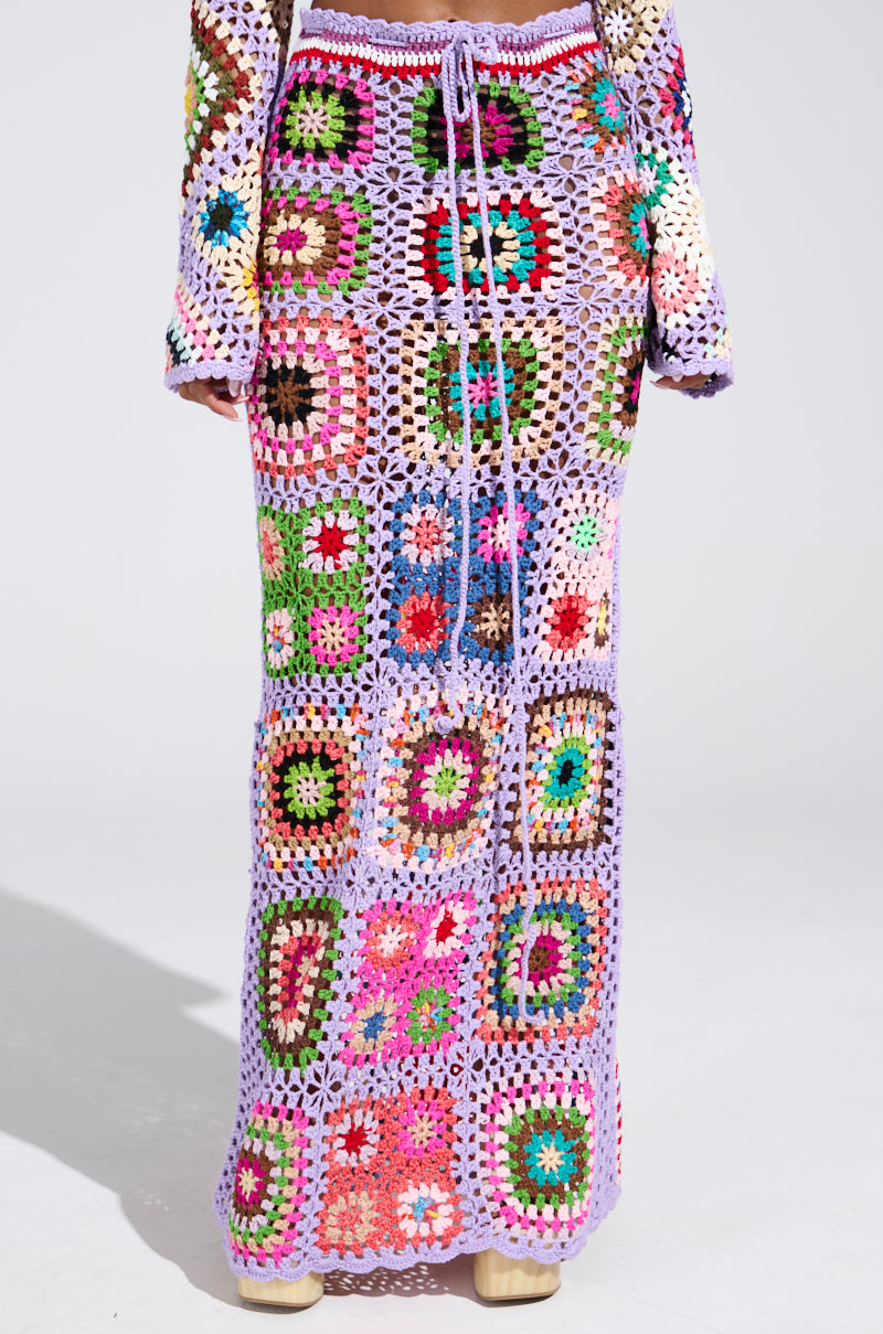 Get ready for summer with the SHINE ON YOUR CROCHET MAXI SKIRT, a vibrant high-rise piece showcasing square patterns in purple, pink, green, and yellow. Its drawstring waist and mesh design highlight intricate multicolored floral motifs.