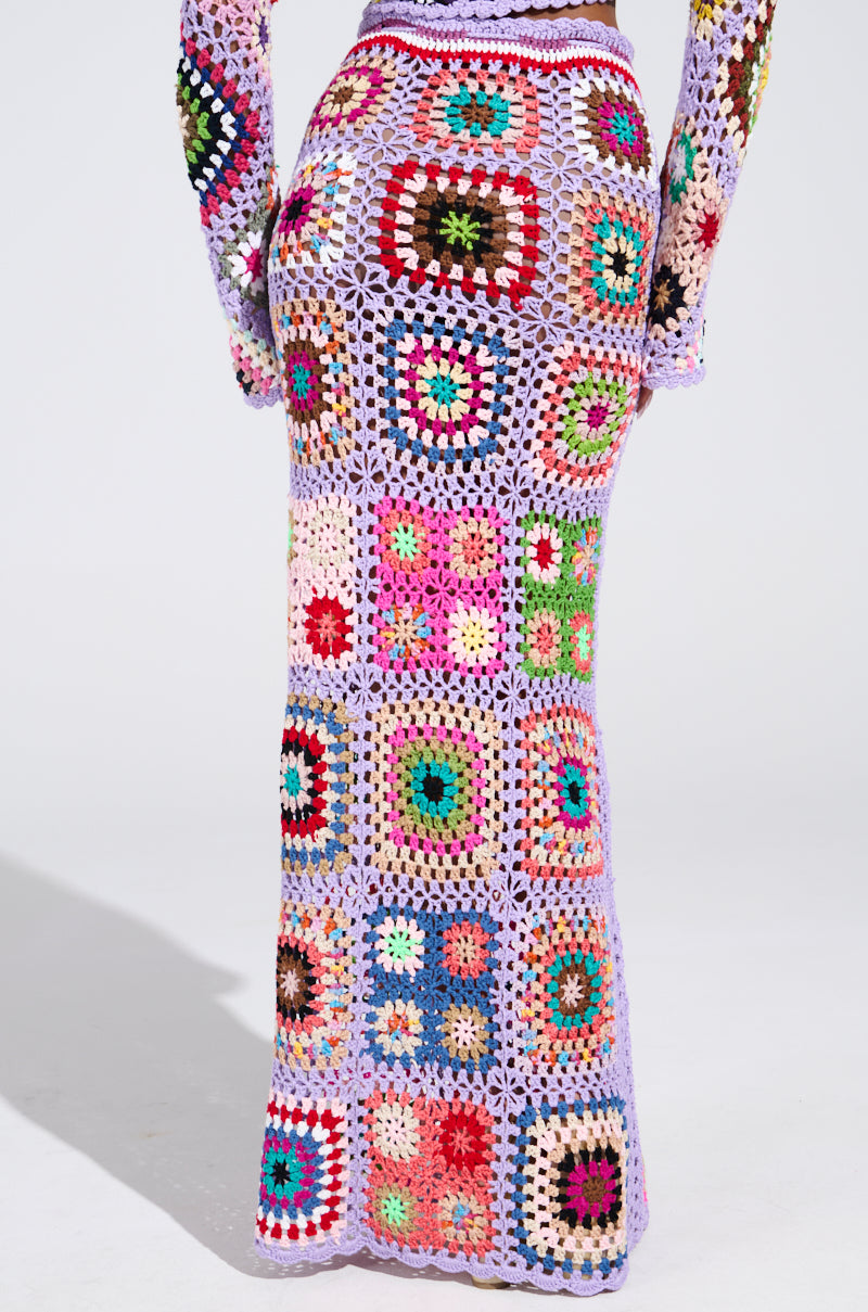 The SHINE ON YOUR CROCHET MAXI SKIRT features a summer style with intricate multicolored square patterns in vibrant hues, blending floral and geometric designs.