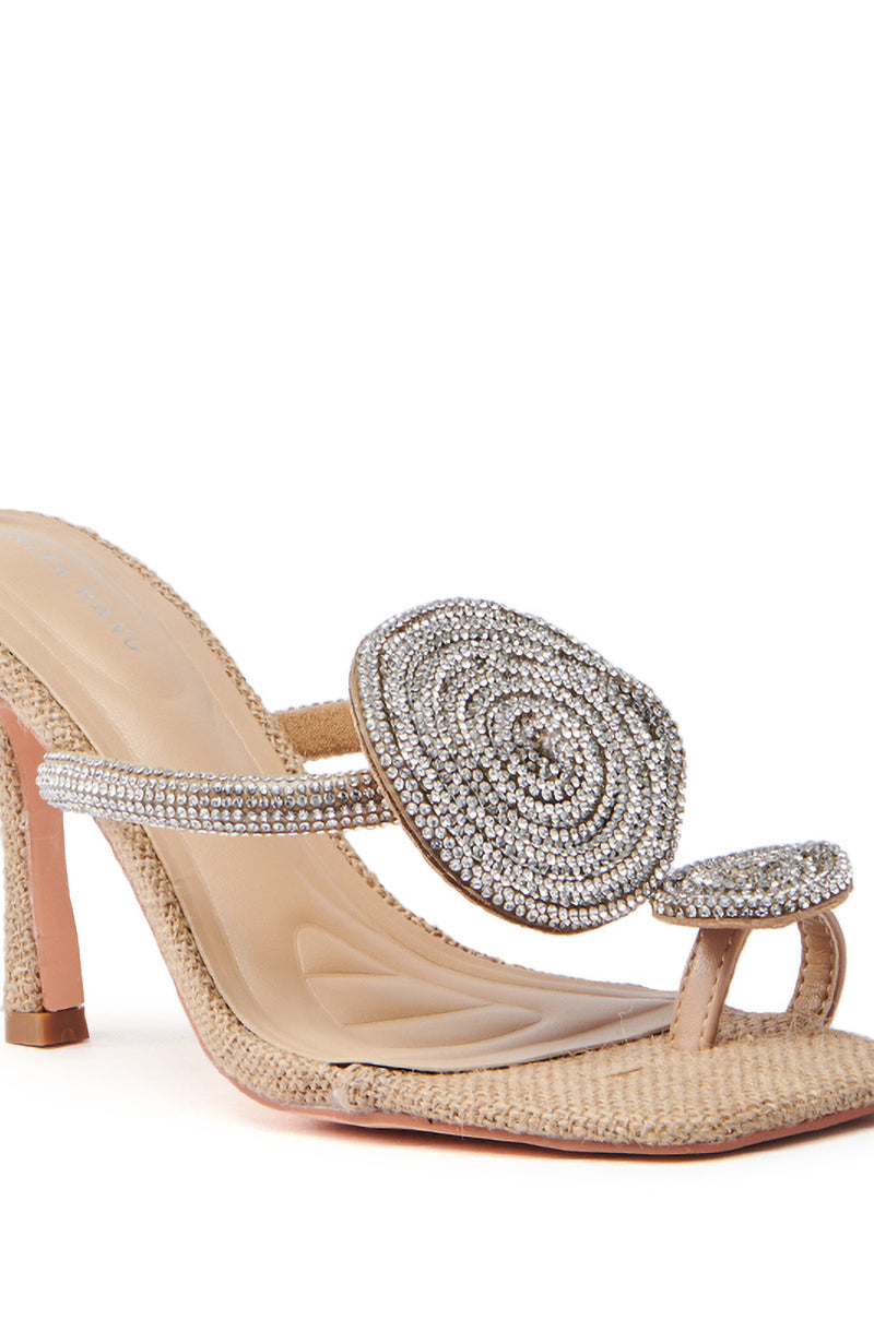The AZALEA WANG DIARA BEIGE RAFFIA EMBELLISHED STILETTO SANDAL features an open-toe design with a rhinestone circular embellishment on the strap, offering elegance and glamor with its slender heel.