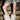 Wearing a camouflage-patterned skirt and AZALEA WANG DIPA IVORY FUR FLAT BOOTIE, a person stands on concrete steps, showing the lower half of their legs.