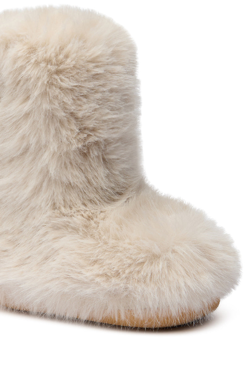 A close-up of the AZALEA WANG DIPA IVORY FUR FLAT BOOTIE, featuring a soft, furry texture and flat sole, displayed against a white background.
