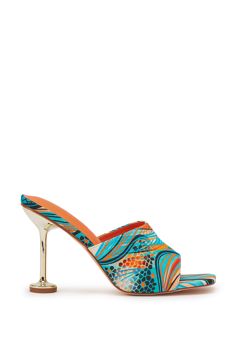 The AKIRA DOMNINA BLUE MULTI STILETTO PRINT SANDAL is a high-heeled slip-on mule with a gold stiletto heel and vibrant blue, orange, and teal abstract patterned upper, comfort cushion insole, shown against a white background. 3