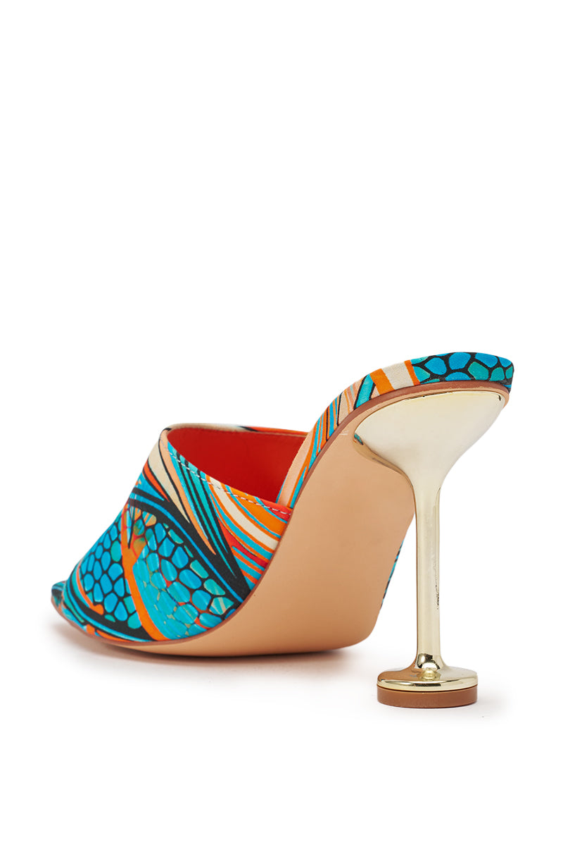 The AKIRA DOMNINA BLUE MULTI STILETTO PRINT SANDAL features a vibrant blue, orange, and turquoise patterned upper, a slim gold metallic heel, and a comfort cushion insole. Shown from the back left angle. 5