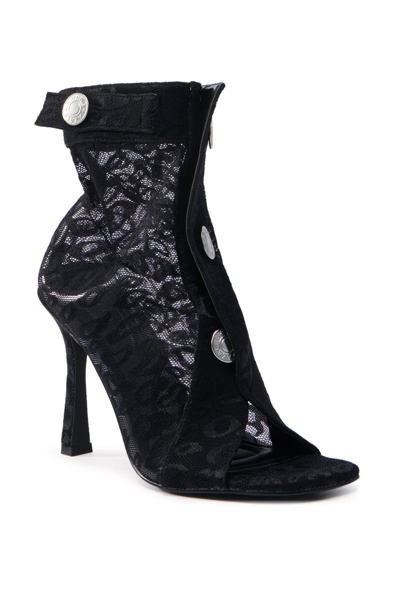 The AZALEA WANG DOROTHY BLACK STILETTO BOOTIE is a black lace high-heeled bootie with a peep toe design, decorative silver buttons, and a patterned mesh textile.