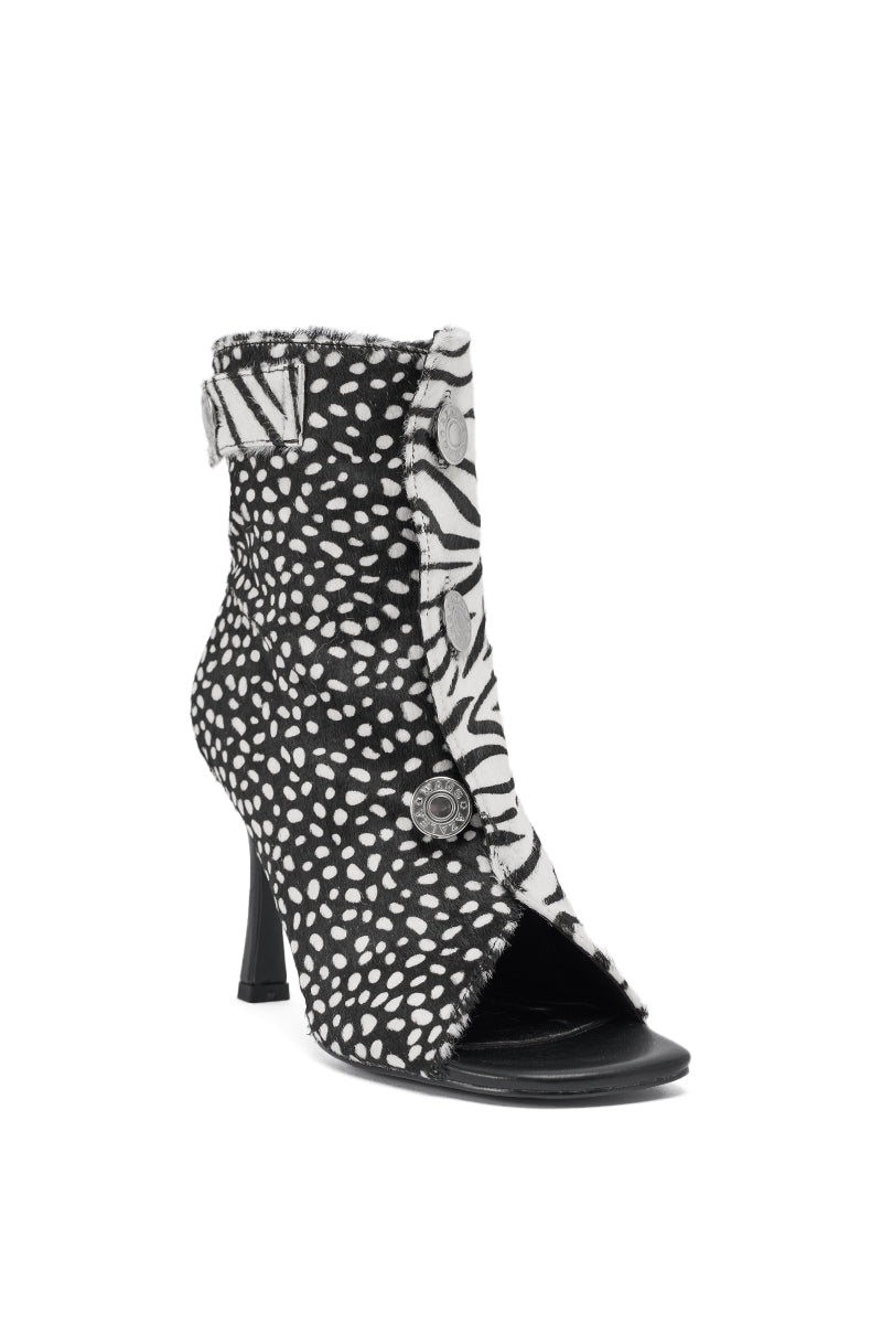 The AZALEA WANG DOROTHY BLACK CHEETAH CALF HAIR PRINTED STILETTO BOOTIE features cheetah print calf hair, a stiletto heel, decorative buttons, an open toe, and a side strap for bold standout style.