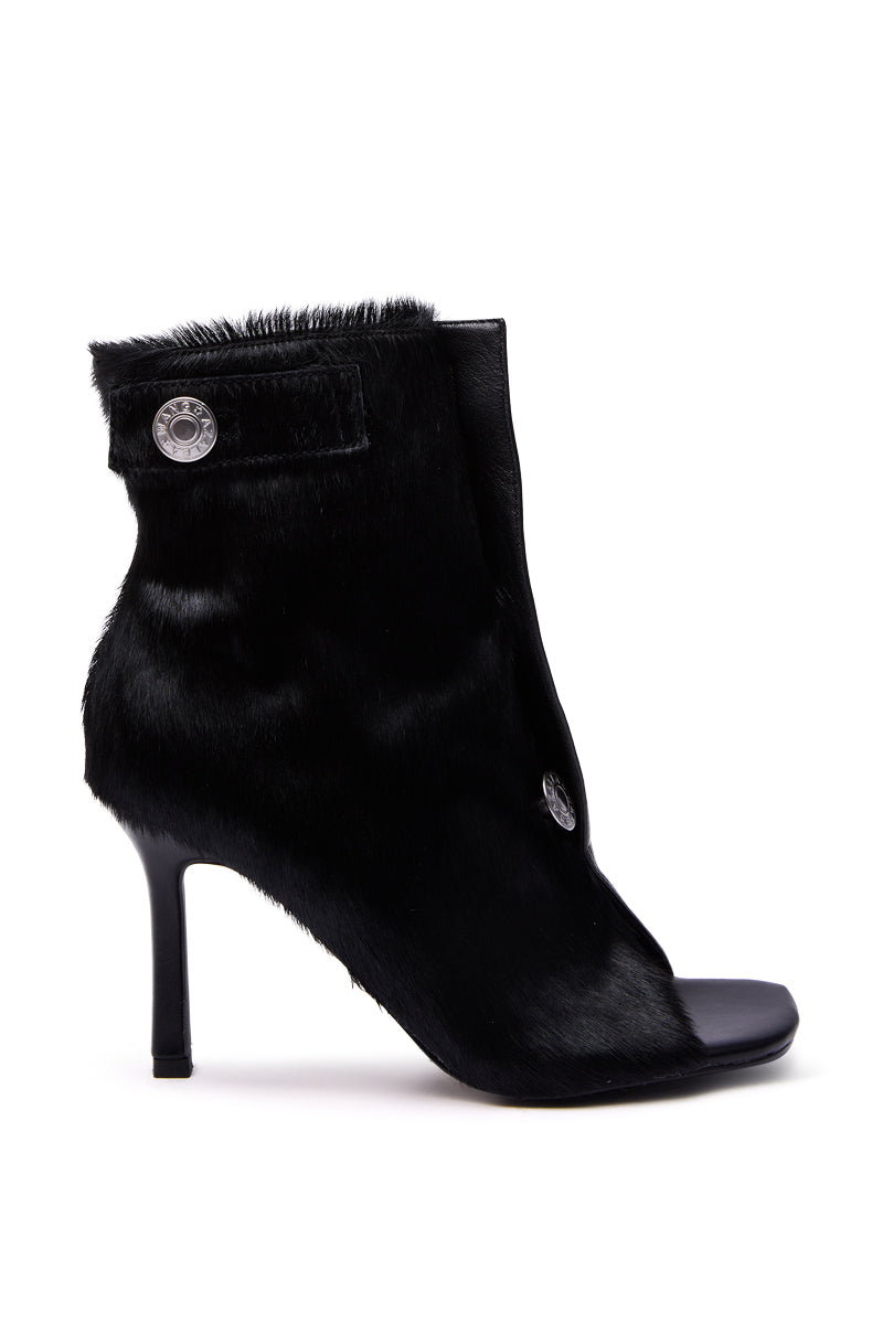 The AZALEA WANG DORTHANDRA Black Pony Hair Paneled Open Toe Bootie features a high stiletto heel and decorative silver side buttons, shown against a plain white background. 4
