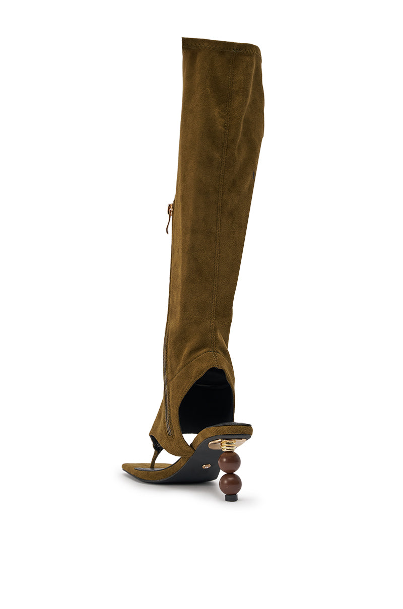 A single AZALEA WANG DOTTIE olive stretch faux suede knee-high boot with an open toe, sculptural embellished heel, and toe hardware is displayed on a white background—a striking women’s fashion statement. 6
