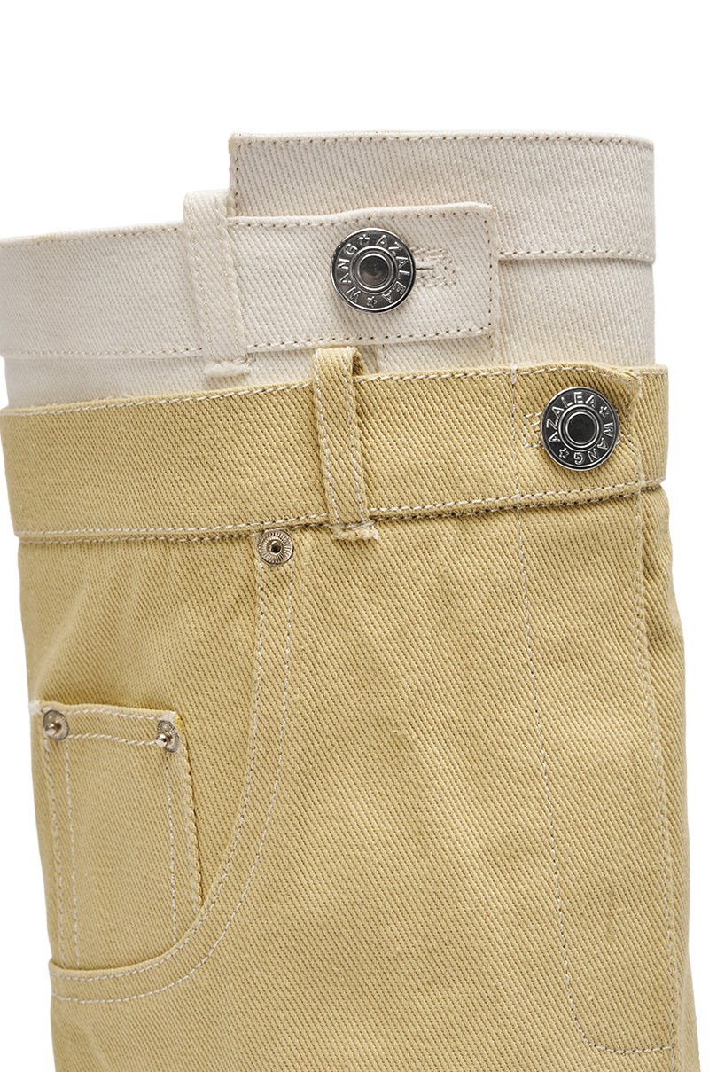 Close-up of cream and light beige jeans with metal buttons and visible stitching, styled perfectly with the AZALEA WANG DOUBLE FLY BEIGE CHUNKY BOOT for a chic, modern look. 6