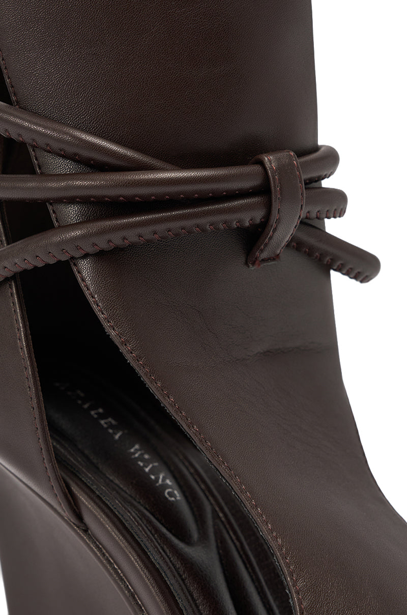 Close-up of the AZALEA WANG DOUMA Chocolate Wedge Lace Up Tall Shaft Sandal, showcasing wrap-around lacing, visible stitching on the upper, and a partially visible brand name on the insole. 6