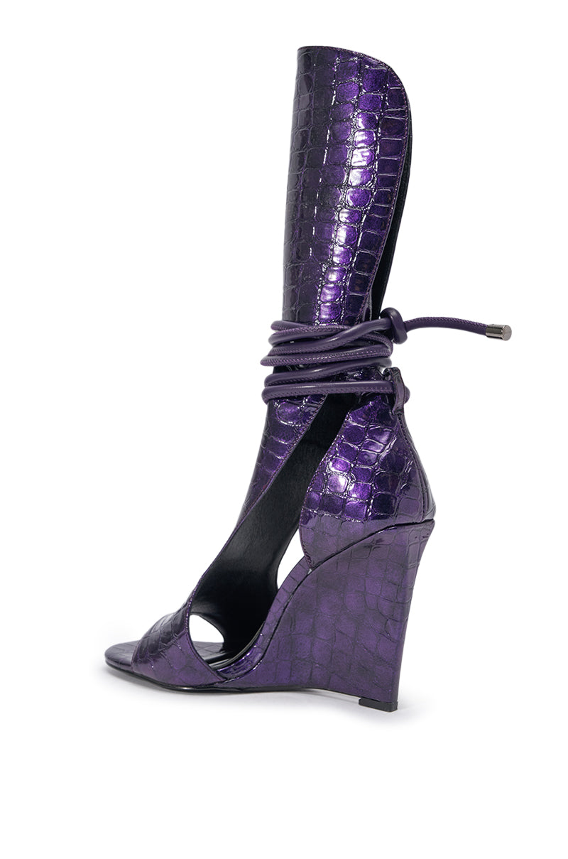 The AZALEA WANG DOUMA PURPLE CROC WEDGE SANDAL features shiny purple faux leather, a croc-embossed finish, high ankle cuff, open toe, and stylish wraparound laces tied at the ankle. 4