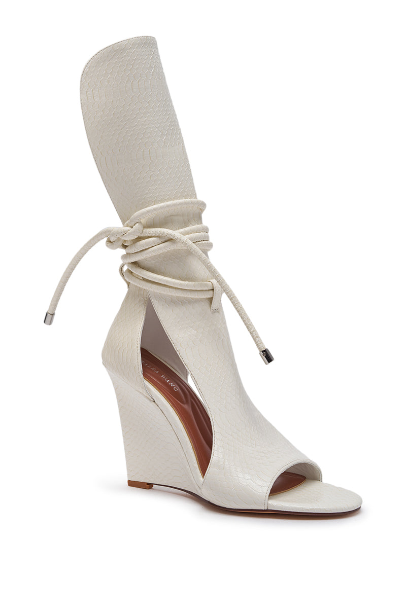 The AZALEA WANG DOUMA White Wedge Lace Up Tall Shaft Sandal features a stylish croc faux leather design, open toe and sides, wedge heel, high ankle wrap, and long laces tied around the upper shaft. 4