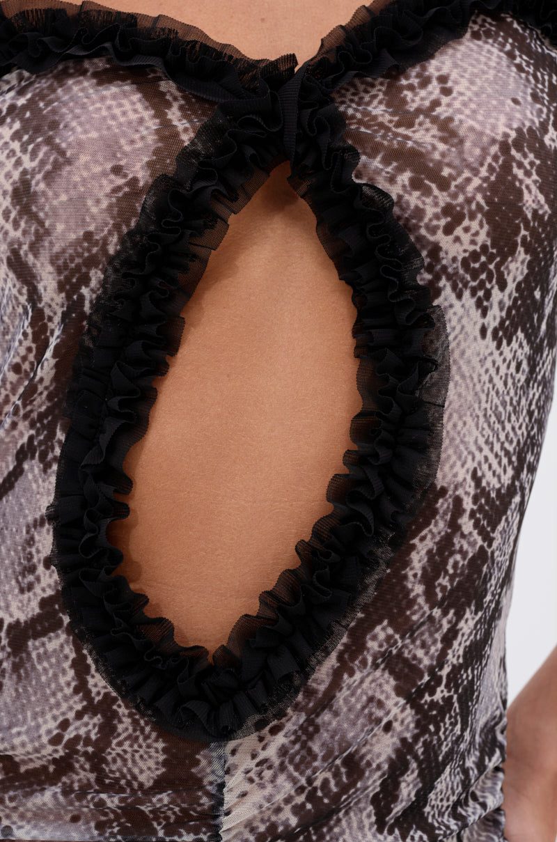 Close-up of the I BITE BACK PRINTED MAXI DRESS, featuring a snakeskin print and a teardrop chest cutout edged with black ruffled trim, revealing skin underneath.