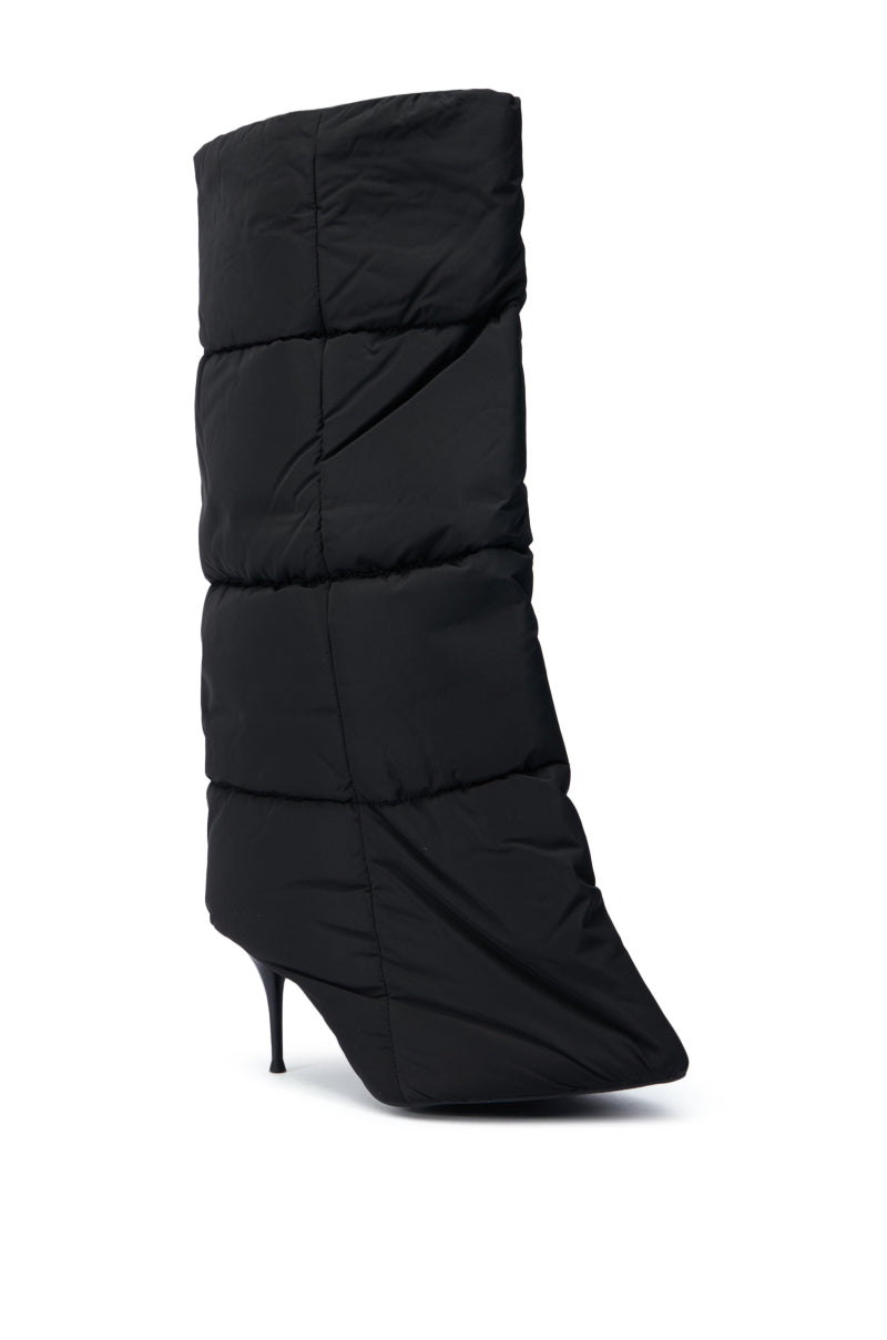 The DREAMSICLE BLACK PUFFER STILETTO BOOT features a sleek black design with a quilted upper and a pointed toe. The high, mid-calf shaft echoes the style of a puffer jacket, all showcased against an elegant white background.
