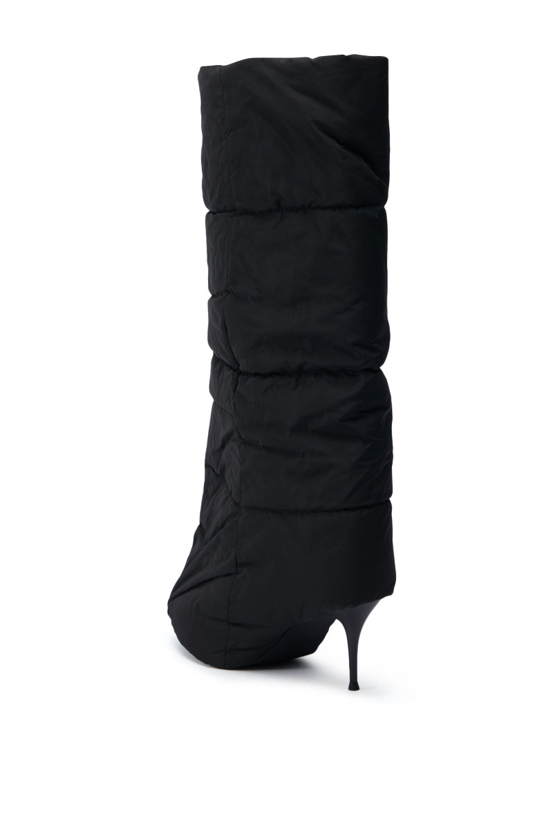A side view of the DREAMSICLE BLACK PUFFER STILETTO BOOT showcases its chic design with a quilted upper and an elegant pointed toe.