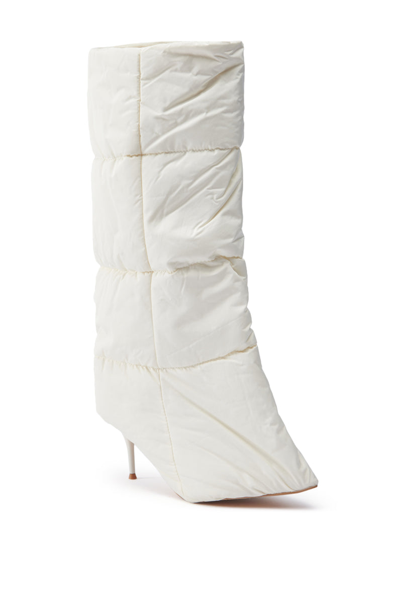 A single DREAMSICLE CREAM PUFFER STILETTO BOOT featuring a quilted design with a pointed toe and slim heel, set against a plain white background. Its sculptural silhouette is reminiscent of a puffer jacket with its padded, square-stitched pattern.