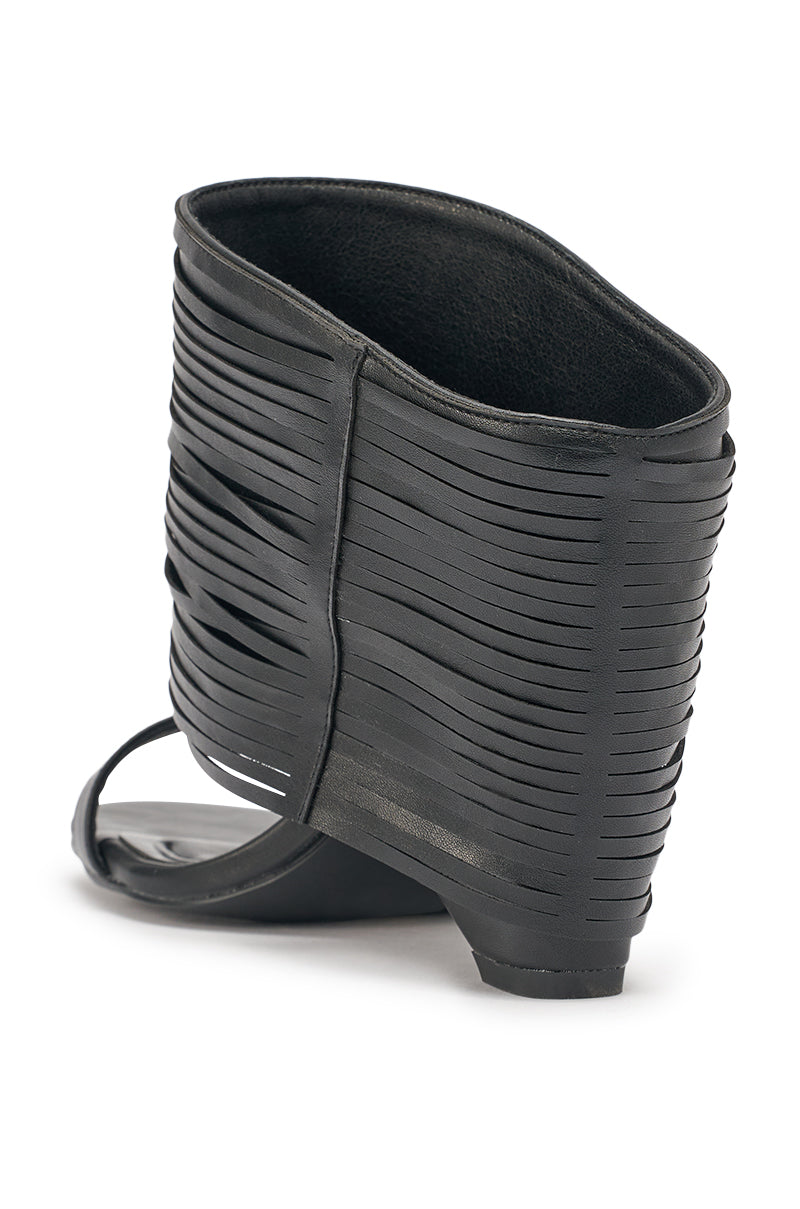 The AZALEA WANG DREIA BLACK PU FRINGE WEDGE SANDAL features an open toe, high ankle cuff with layered leather straps, a low angled wedge heel, and a comfort cushion insole for lasting support. 5