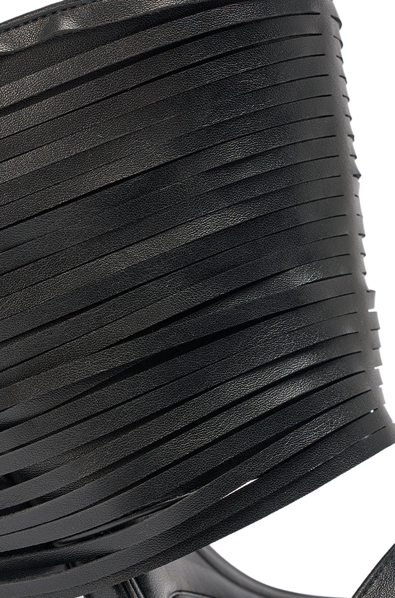 Close-up of the AZALEA WANG DREIA BLACK PU FRINGE WEDGE SANDAL shows thin, layered black PU straps with a textured, slightly glossy finish and subtle fringe detailing. 6