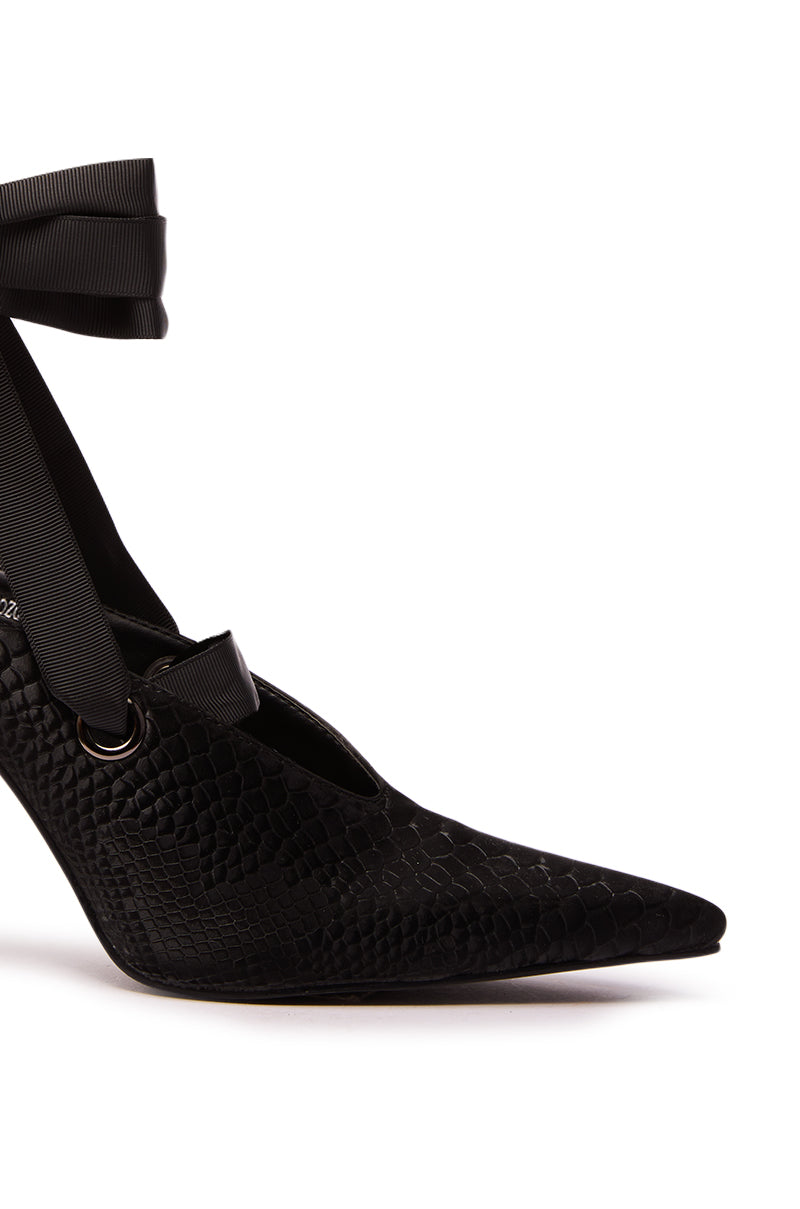 The AZALEA WANG DRODZOV BLACK LIQUID LUXE RIBBON TIE PUMP features a pointed toe, textured snakeskin print heel, and elegant ankle ribbon, set against a white background.