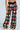 Sport the FESTIVAL GIRLY OVERSIZED CROCHET PANT, made of colorful granny squares in vibrant hues like red, orange, blue, and green against a plain background. Paired with red and white sneakers, this playful look radiates energy.