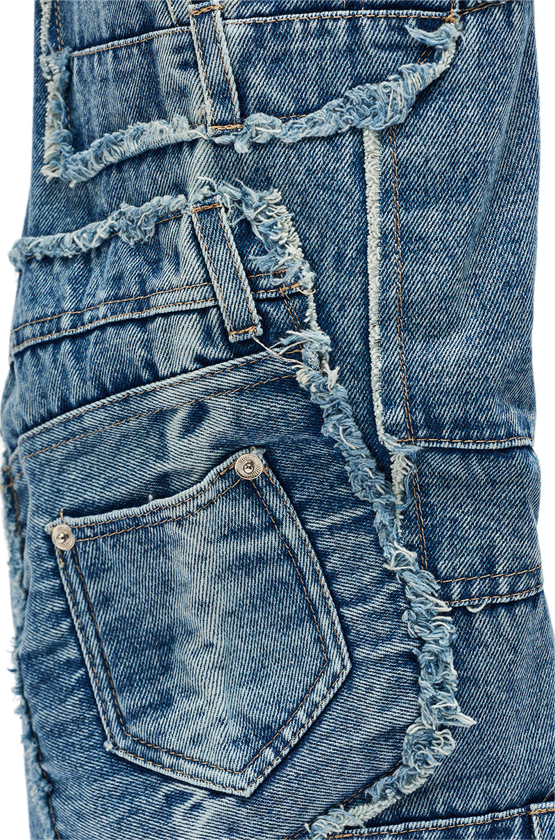 Close-up of a pair of jeans styled with the AZALEA WANG DUMI DENIM CHUNKY PATCHWORK BOOT. 8