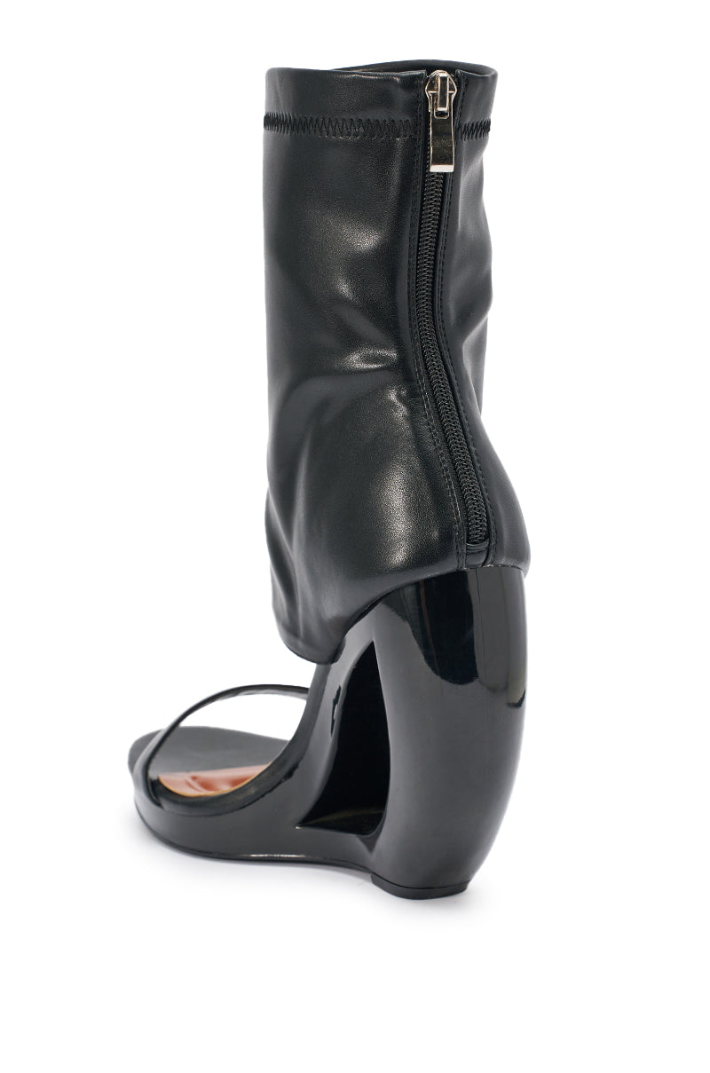 The AKIRA GOLD DUMISANI BLACK WEDGE OPEN TOE BOOTIE features a sculptural curved heel, sock-like black leather upper, back zipper, and a modern, unconventional design. 4