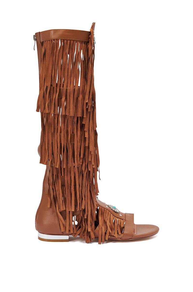 The AZALEA WANG DUSTINE BROWN GLADIATOR EMBELLISHED SANDAL is a knee-high, open-toe design in brown leather with multiple layers of long fringe on the shaft and bold turquoise embellishments on the front. 4