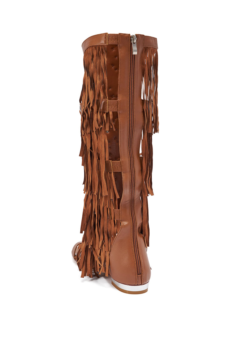 The AZALEA WANG DUSTINE BROWN GLADIATOR EMBELLISHED SANDAL features a knee-high design with multiple fringe layers and a vertical back zipper, displayed from the rear on a white background. 6