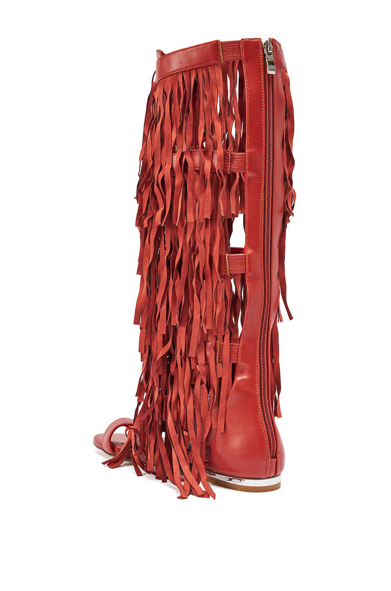 The AZALEA WANG DUSTINE Red Multi Gladiator Embellished Sandal is a tall red knee-high sandal with a side zipper, long red fringe, flat sole, and open toe for a bold layered bohemian look. 4