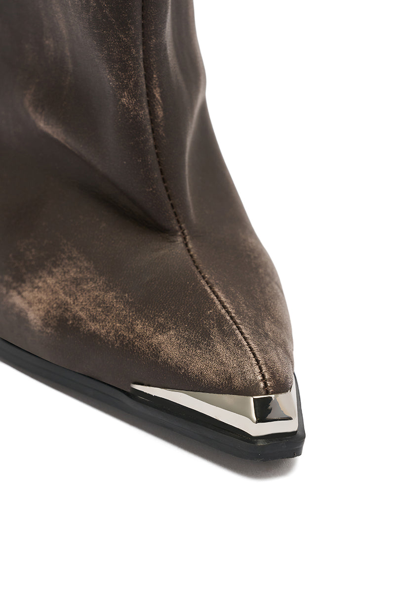 Close-up of the pointed toe of the AZALEA WANG DUSTY BROWN WEATHERED PU BOOT, showing a metallic silver tip accent, visible stitching, and a black sole.