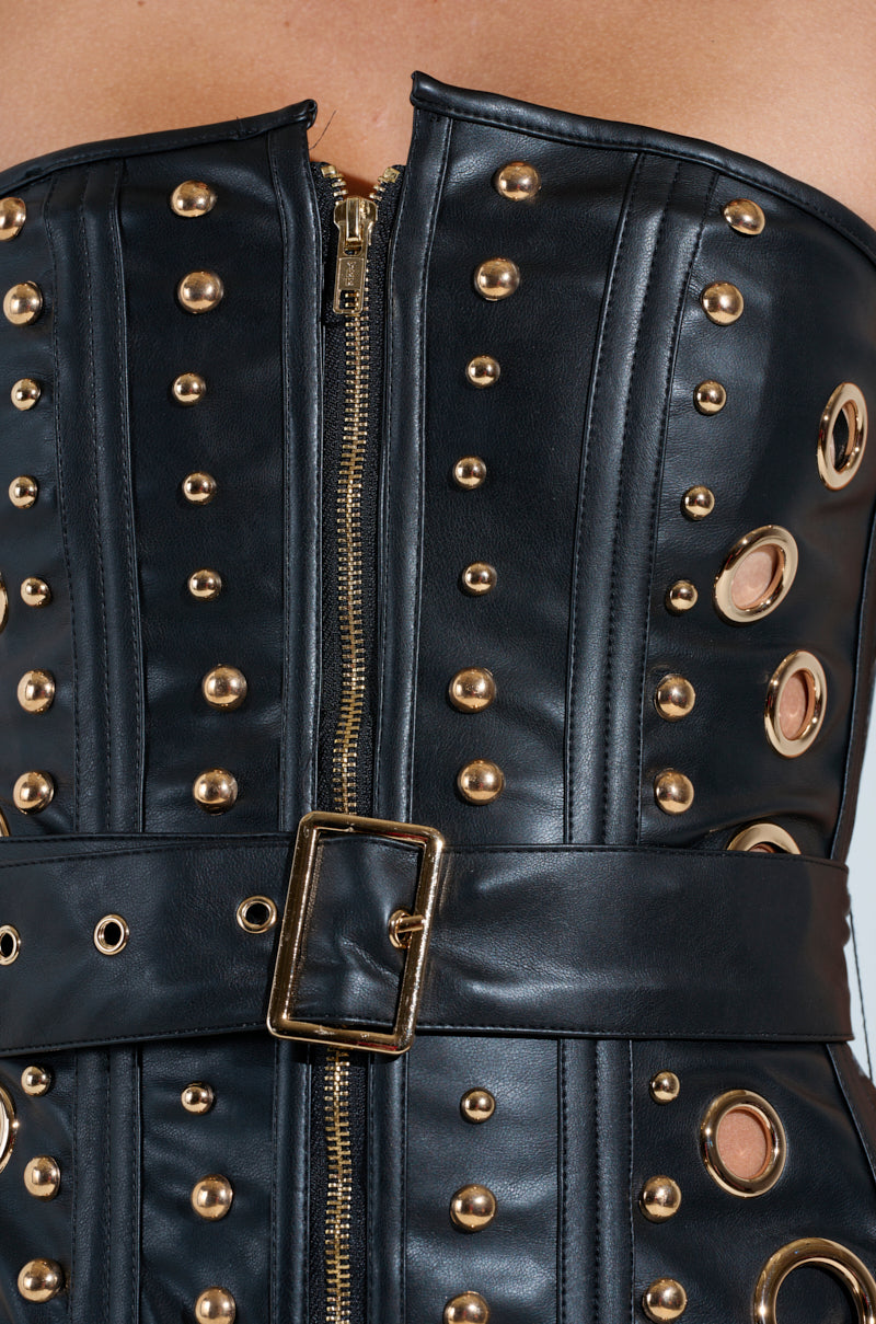 Close-up of the DW Studded Corset in sleek black faux leather, showcasing metallic hardware with gold studs and eyelets, a front zipper, and a belt with a rectangular gold buckle for an edgy fashion statement.