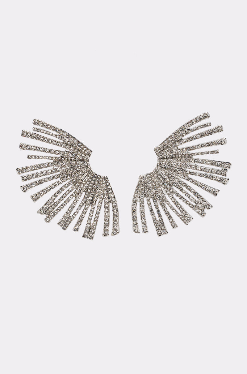 Pair of glamorous CRYSTAL STARBURST EARRINGS IN CLEAR featuring a fan-shaped design with silver rhinestones arranged in radiating lines, creating a stunning sunburst or wing-like effect, displayed on a plain white background.