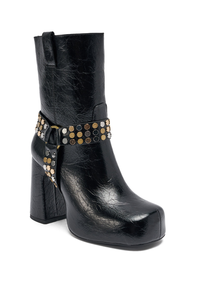 The AZALEA WANG MID CALF PU LEATHER CHUNKY BOOTIE is a black, faux leather bootie featuring a square toe, chunky heel, and an ankle strap adorned with gold and silver-tone studs.