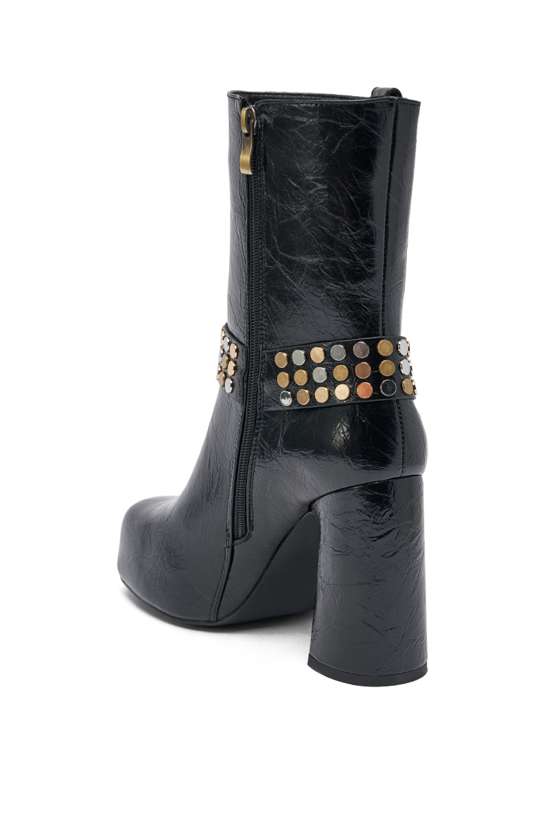 The AZALEA WANG MID CALF PU LEATHER CHUNKY BOOTIE features a black faux leather finish, side zipper, and ankle strap adorned with gold and silver studs—perfect for adding edgy style to any outfit.