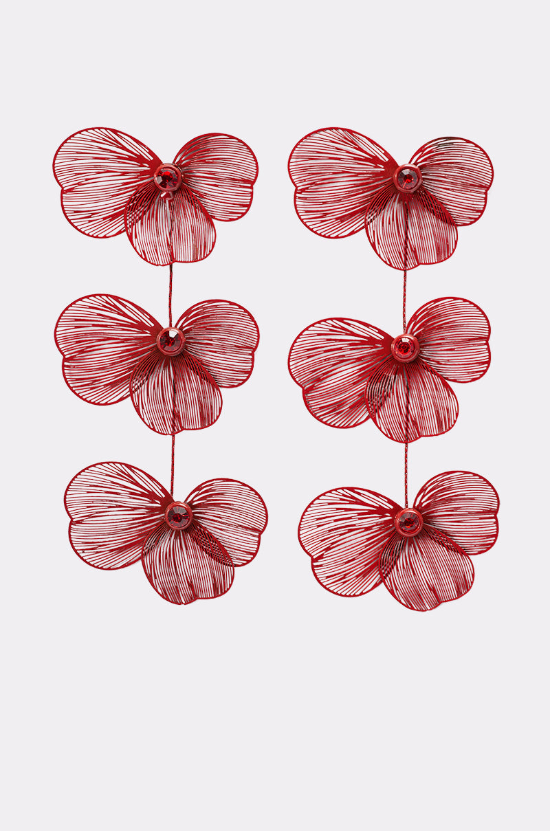 Six red-tone metal flowers, shaped like orchids with overlapping petals and round centers, are arranged in two vertical columns on a plain white background. These blooms evoke the floral-inspired MY FUTURE EARRING design. 1