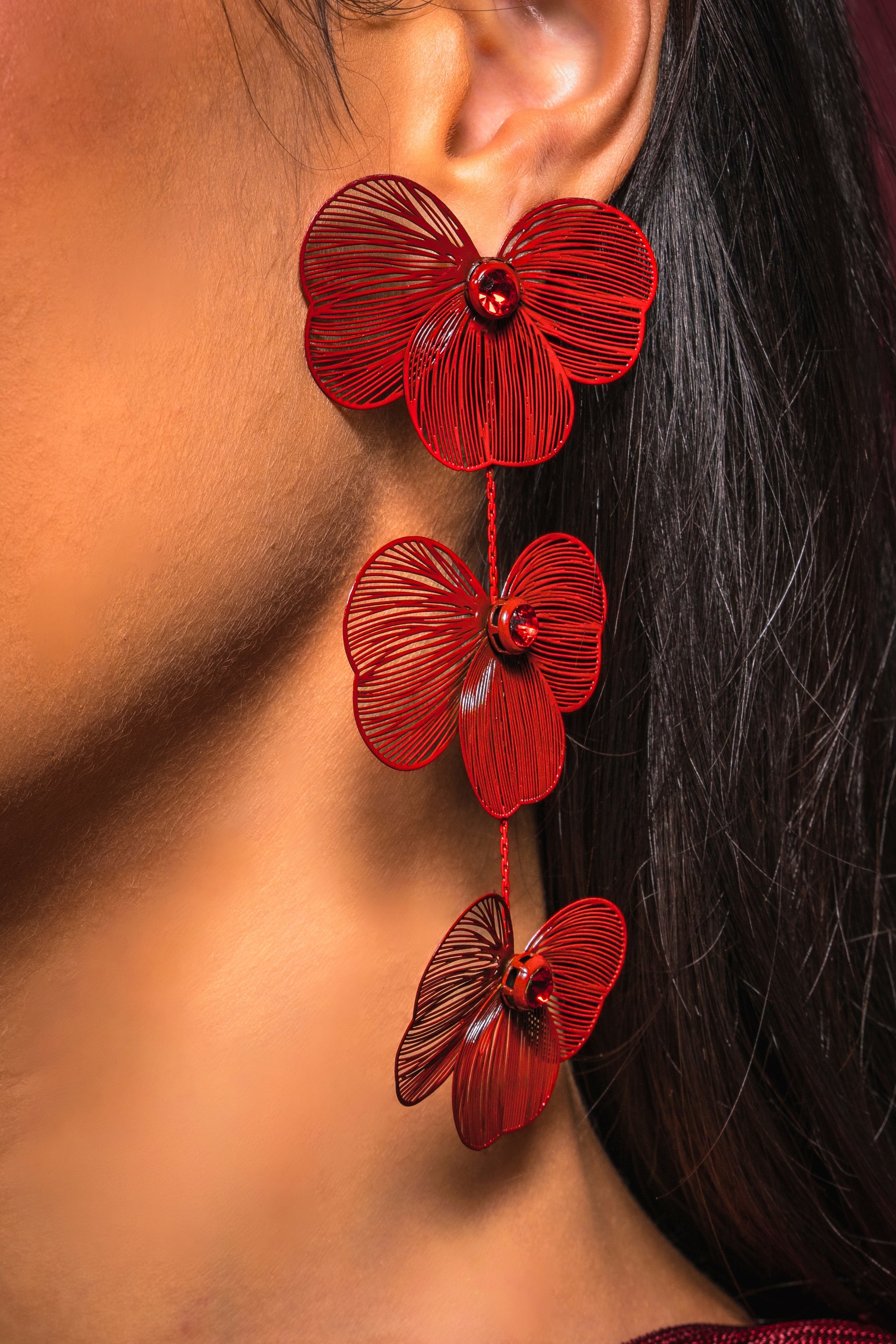 A close-up of a woman's neck adorned with MY FUTURE EARRING statement drop earrings. 0