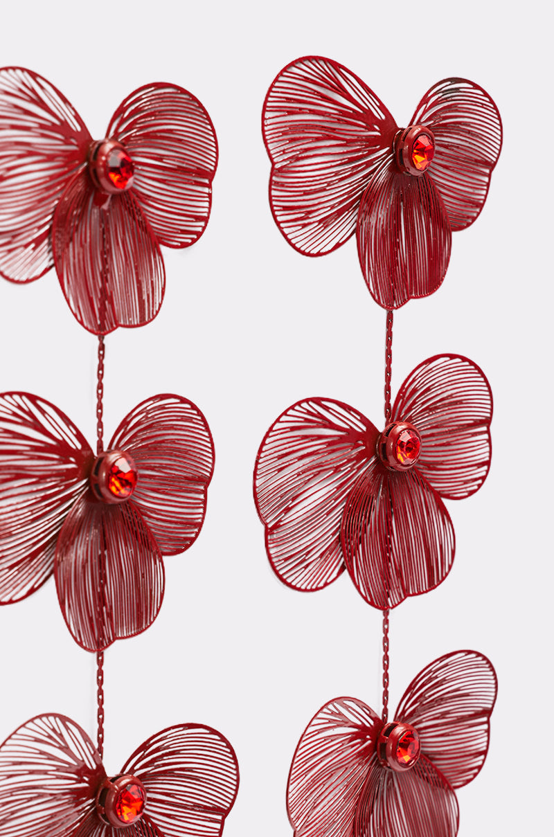 Close-up of MY FUTURE EARRING: decorative red-tone earrings with intricate wire petals and small red gem centers, arranged vertically on a light grey background, highlighting their floral-inspired elegance. 3