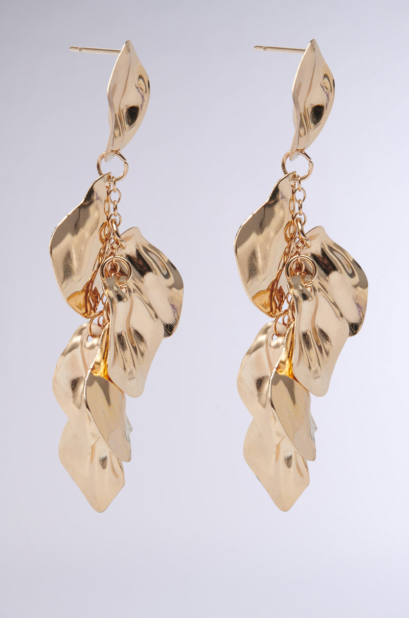 The NO THANKS EARRING features abstract, textured faux gold leaf-shaped dangles with a shiny crumpled finish, linked in a cascading chain drop design, shown against a plain light gray background. 4