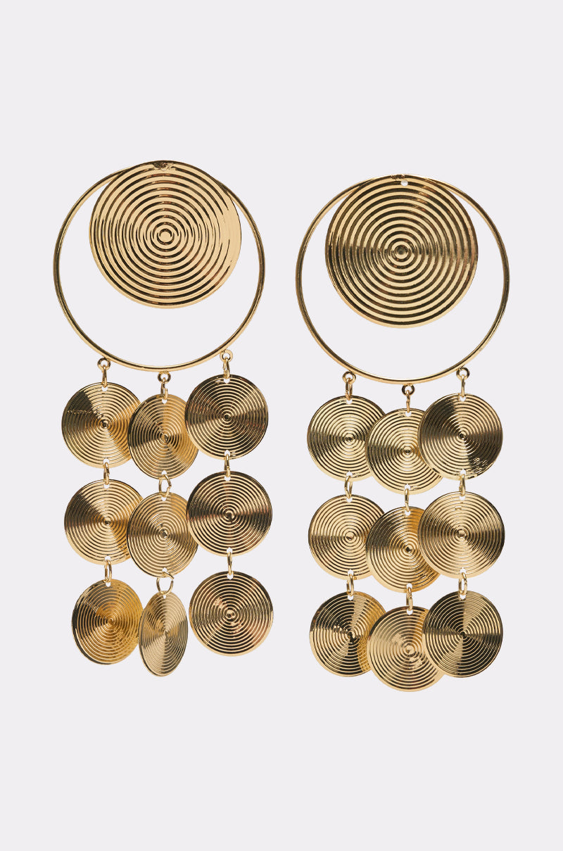 The TAKE ME AWAY EARRING is a pair of gold disc drop earrings with concentric circular patterns, featuring a large top circle and three rows of smaller dangling circles—ideal statement pieces for parties. 4