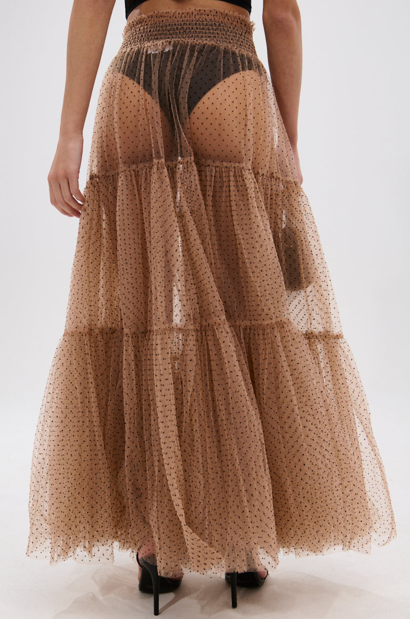 Wearing the CLASSY POLKA DOT MAXI SKIRT in sheer tan organza with tiered, flowy layers and velvet polka dots; black underwear is visible beneath, shown from lower back to feet. 4
