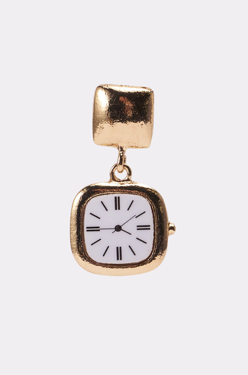 The OUTTA TIME EARRING from AKIRA Label features a gold square clock pendant with a white face and black Roman numerals attached to a textured gold stud—ideal for fans of unique, square statement earrings. 3