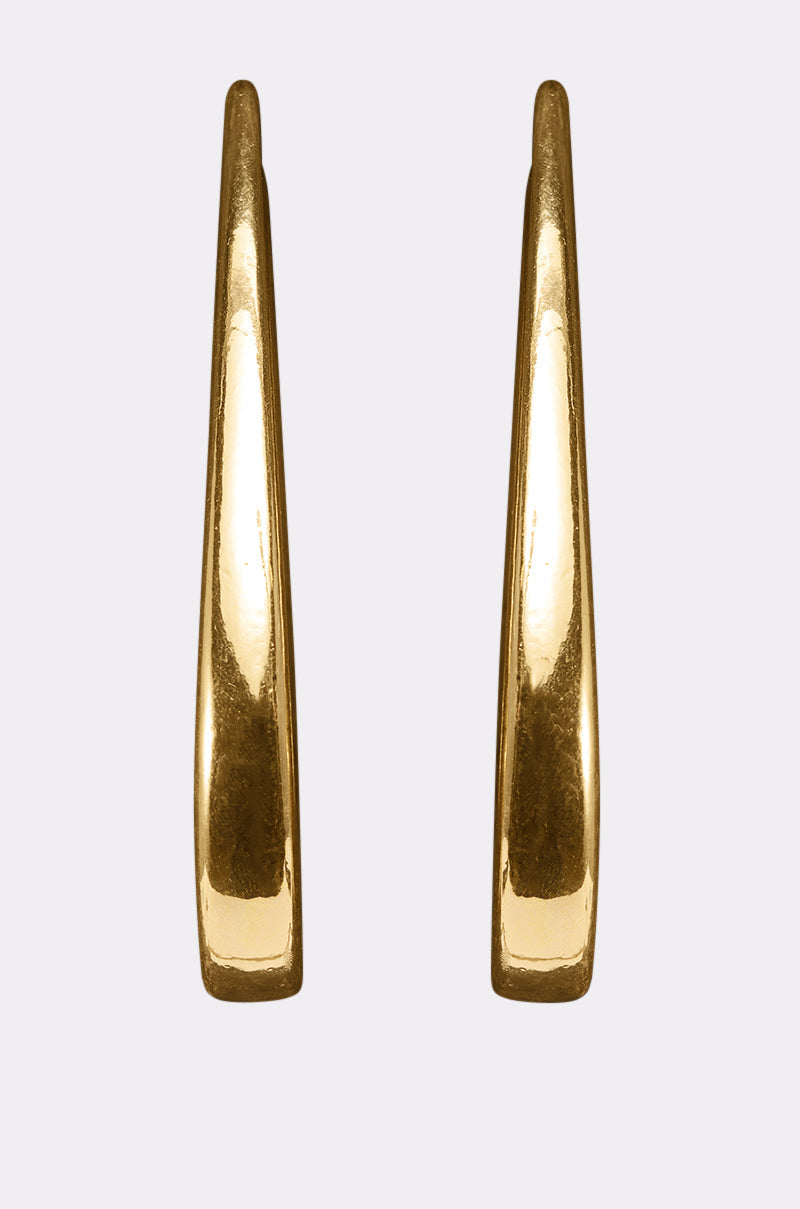 The BELLE EARRING is a pair of polished gold-tone hoops featuring an elongated, tapered teardrop design, shown against a plain light gray background. 3