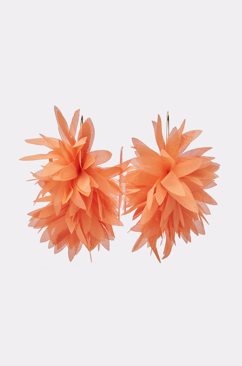 The FOR THE SUMMER EARRING features orange flower-shaped earrings with layered, pointed petals forming a round, pom-pom design, shown on a plain white background. 3