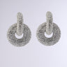 LUXURY EARRING: Silver circular earrings featuring a textured design and rhinestone embellishments at the looped top section, set against a light gray background.